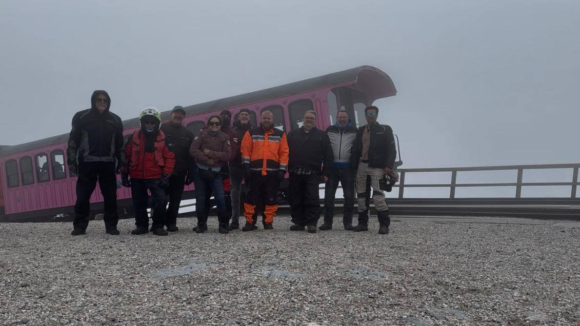 Full group at the summit with the cog railway